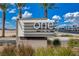 Modern community sign featuring desert landscaping, blue skies, and palm trees at 8255 S Las Vegas Blvd # 2004, Las Vegas, NV 89123