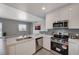 Bright open kitchen with stainless appliances, white cabinets and stone countertops at 8255 S Las Vegas Blvd # 2004, Las Vegas, NV 89123