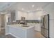 Bright, modern kitchen with white cabinets, stainless steel appliances, and a quartz countertop peninsula at 8255 S Las Vegas Blvd # 2004, Las Vegas, NV 89123