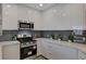 A kitchen featuring sleek, modern design with stainless steel appliances and stylish gray backsplash at 8255 S Las Vegas Blvd # 2004, Las Vegas, NV 89123