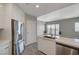 Modern kitchen with stainless steel refrigerator and a view into an open living space at 8255 S Las Vegas Blvd # 2004, Las Vegas, NV 89123