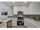 A kitchen featuring sleek, modern design with stainless steel appliances and stylish gray backsplash at 8255 S Las Vegas Blvd # 2004, Las Vegas, NV 89123