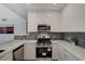 A kitchen featuring sleek, modern design with stainless steel appliances and stylish gray backsplash at 8255 S Las Vegas Blvd # 2004, Las Vegas, NV 89123