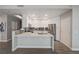 Modern kitchen with white cabinets, stainless steel appliances, and a peninsula island with breakfast bar at 8255 S Las Vegas Blvd # 2004, Las Vegas, NV 89123