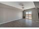 A bright living room area with neutral walls and tile floors that lead to a balcony at 8255 S Las Vegas Blvd # 2004, Las Vegas, NV 89123