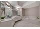 Bright main bathroom featuring double sinks, a soaking tub, and tile flooring at 8255 S Las Vegas Blvd # 2004, Las Vegas, NV 89123