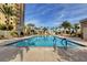 Outdoor swimming pool surrounded by palm trees and lounge chairs under a sunny blue sky at 8255 S Las Vegas Blvd # 2004, Las Vegas, NV 89123