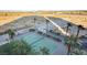 Aerial view of a community tennis court surrounded by lush landscaping and palm trees at 8255 S Las Vegas Blvd # 2004, Las Vegas, NV 89123