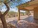 Inviting back patio with covered area, desert landscaping and wrought iron fence at 8409 Sherwood Park Dr, Las Vegas, NV 89131