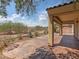 Inviting back patio with covered area, desert landscaping and wrought iron fence at 8409 Sherwood Park Dr, Las Vegas, NV 89131