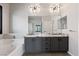 Spacious bathroom featuring a soaking tub, granite counters, and double sinks at 8409 Sherwood Park Dr, Las Vegas, NV 89131