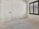 This bedroom features a window with shutters, white carpet and closet at 8409 Sherwood Park Dr, Las Vegas, NV 89131