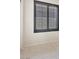 Bright bedroom with neutral carpet, a large window and plantation shutters at 8409 Sherwood Park Dr, Las Vegas, NV 89131