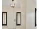 Front entryway features a modern light fixture and views through dark-framed windows at 8409 Sherwood Park Dr, Las Vegas, NV 89131