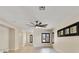 Spacious living room boasts a ceiling fan and dark-framed windows for natural light at 8409 Sherwood Park Dr, Las Vegas, NV 89131