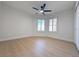 Bright bedroom with wood-look floors, shuttered windows and ceiling fan at 9369 Villa Ridge Dr, Las Vegas, NV 89134