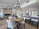 Open-concept dining area with modern lighting and a seamless connection to the stylish kitchen at 9369 Villa Ridge Dr, Las Vegas, NV 89134