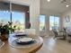 Dining room table setting showcasing natural light and view into the spacious living area at 9369 Villa Ridge Dr, Las Vegas, NV 89134