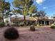 Attractive single-story home with a tile roof and mature landscaping, offering great curb appeal at 9369 Villa Ridge Dr, Las Vegas, NV 89134