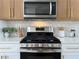 Modern kitchen with stainless steel appliances and updated backsplash at 9369 Villa Ridge Dr, Las Vegas, NV 89134