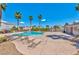 Relaxing community pool with lounge chairs surrounded by palm trees and nearby restrooms at 9979 Keephills St, Las Vegas, NV 89183