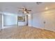Bright and open-concept living room featuring tile floors, ceiling fan, and access to the kitchen at 9979 Keephills St, Las Vegas, NV 89183