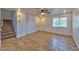 Spacious living room boasting tiled floors, a ceiling fan, a staircase and great natural light at 9979 Keephills St, Las Vegas, NV 89183