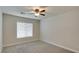 Cozy bedroom with carpet, ceiling fan, and a window offering natural light at 9994 Government Point Way # 101, Las Vegas, NV 89183