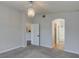 Carpeted bedroom with an elegant chandelier and connecting bathroom at 9994 Government Point Way # 101, Las Vegas, NV 89183