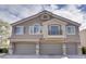 Inviting two-story home with a three-car garage and well-maintained landscaping at 9994 Government Point Way # 101, Las Vegas, NV 89183