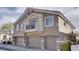 Attractive townhome featuring a three-car garage and desert landscaping at 9994 Government Point Way # 101, Las Vegas, NV 89183