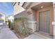 Townhome front entrance with neutral desert colors and minimal landscaping at 9994 Government Point Way # 101, Las Vegas, NV 89183