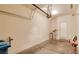 Spacious garage with concrete floor, door to the house, and garage door opener at 9994 Government Point Way # 101, Las Vegas, NV 89183