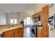 Open kitchen with stainless steel appliances and a breakfast bar at 9994 Government Point Way # 101, Las Vegas, NV 89183
