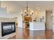 Open-concept living room with a fireplace and adjoined kitchen area at 9994 Government Point Way # 101, Las Vegas, NV 89183