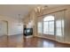 Spacious living room showcasing a fireplace, large window, and wood floors at 9994 Government Point Way # 101, Las Vegas, NV 89183