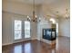 Bright living room featuring wood floors, fireplace, and balcony access at 9994 Government Point Way # 101, Las Vegas, NV 89183