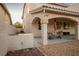 Backyard featuring a covered patio, built-in grill, and neutral stone landscaping at , Las Vegas, NV 89117