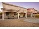 Spacious backyard with covered patio, stone landscaping, and seating area at , Las Vegas, NV 89117