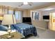Spacious bedroom with a TV and ensuite sitting area; it features a ceiling fan, plush carpets, and natural light at , Las Vegas, NV 89117