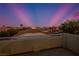 Panoramic view of a desert community under a twilight sky with palm trees and a cityscape visible in the distance at , Las Vegas, NV 89117