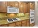 Well-equipped kitchen featuring granite countertops, a cooktop, double ovens, and ample cabinetry for storage at , Las Vegas, NV 89117