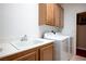 Functional laundry room with cabinets, sink, and modern washer and dryer at , Las Vegas, NV 89117