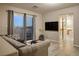Inviting living room with a comfortable gray sofa, TV, and sliding glass doors to a balcony overlooking a picturesque view at , Las Vegas, NV 89117