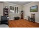 A well-lit office space featuring hardwood floors, a large window, and ample storage at , Las Vegas, NV 89117