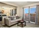 Charming sitting room featuring a comfortable gray sofa, a modern table, and a view into the main bedroom at , Las Vegas, NV 89117