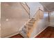 Carpeted staircase with wooden railing and hardwood flooring at the base at , Las Vegas, NV 89117