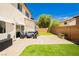 Well-maintained backyard with patio seating area, artificial turf, and a privacy fence for outdoor enjoyment at , Las Vegas, NV 89178