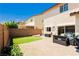 Inviting backyard boasting a paved patio, artificial grass, a retaining wall, and comfortable seating at , Las Vegas, NV 89178