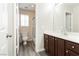 Bathroom featuring a mirror, toilet, sink, and a shower tub with a window providing natural light at , Las Vegas, NV 89178